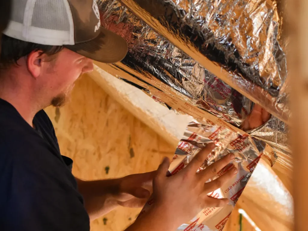 An Annette Hale expert enhancing home insulation to support air conditioning efficiency.