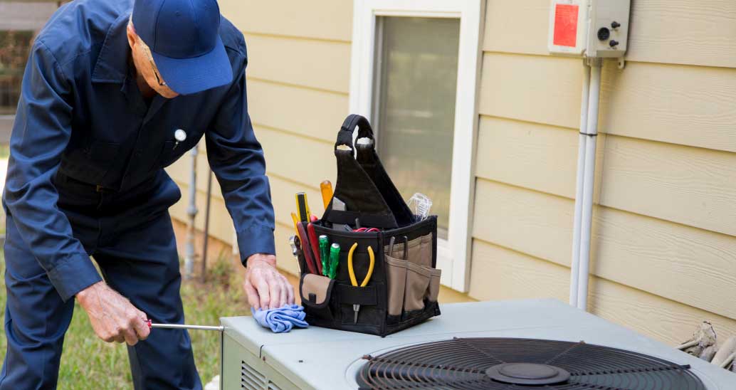 An AC technician repairing a broken AC